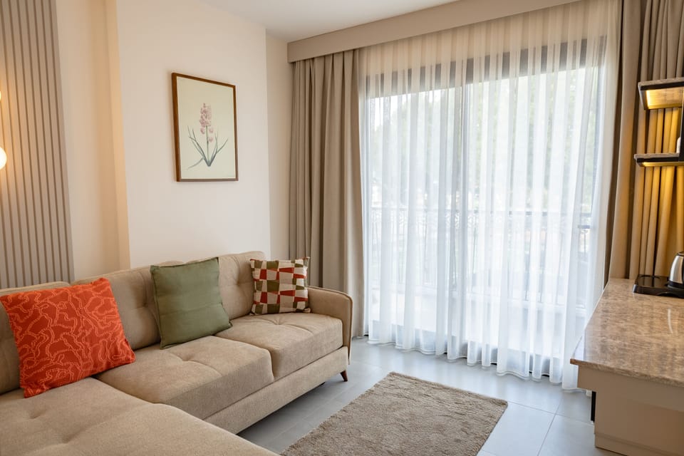Deluxe Suite, Balcony, City View | Living area | 110-cm LED TV with satellite channels