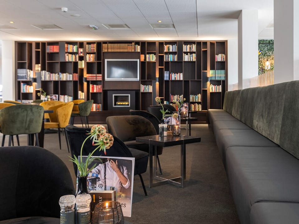 Relax fireside with a book in our cozy lounge corner.