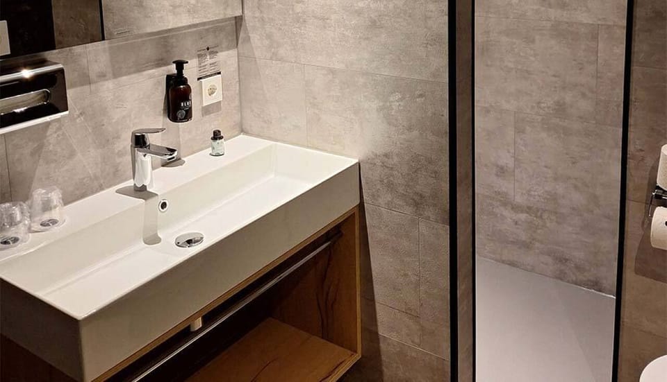 Refresh under a sleek rain shower in spa-like calm.