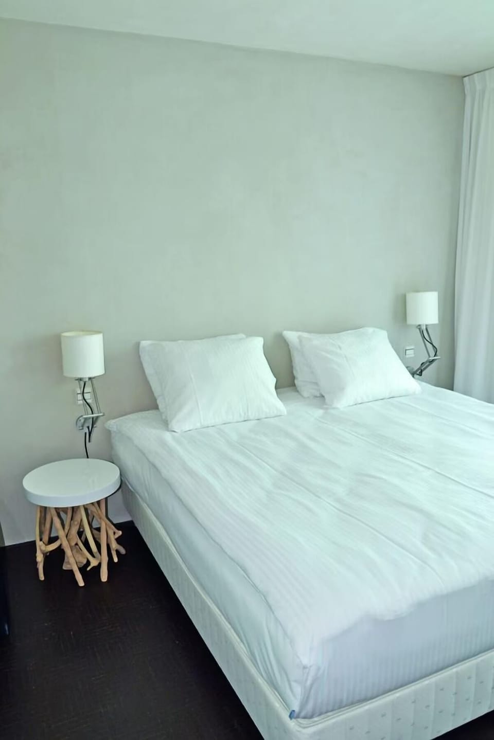 Drift off in crisp linens with minimalist, calming style.