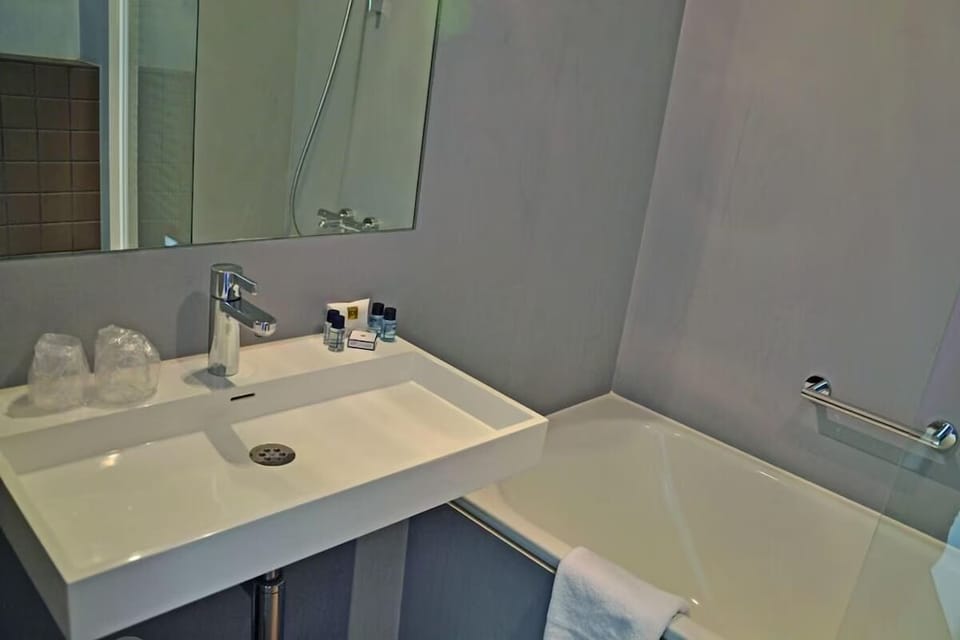Refresh with a soak-ready tub and neatly stocked vanity.