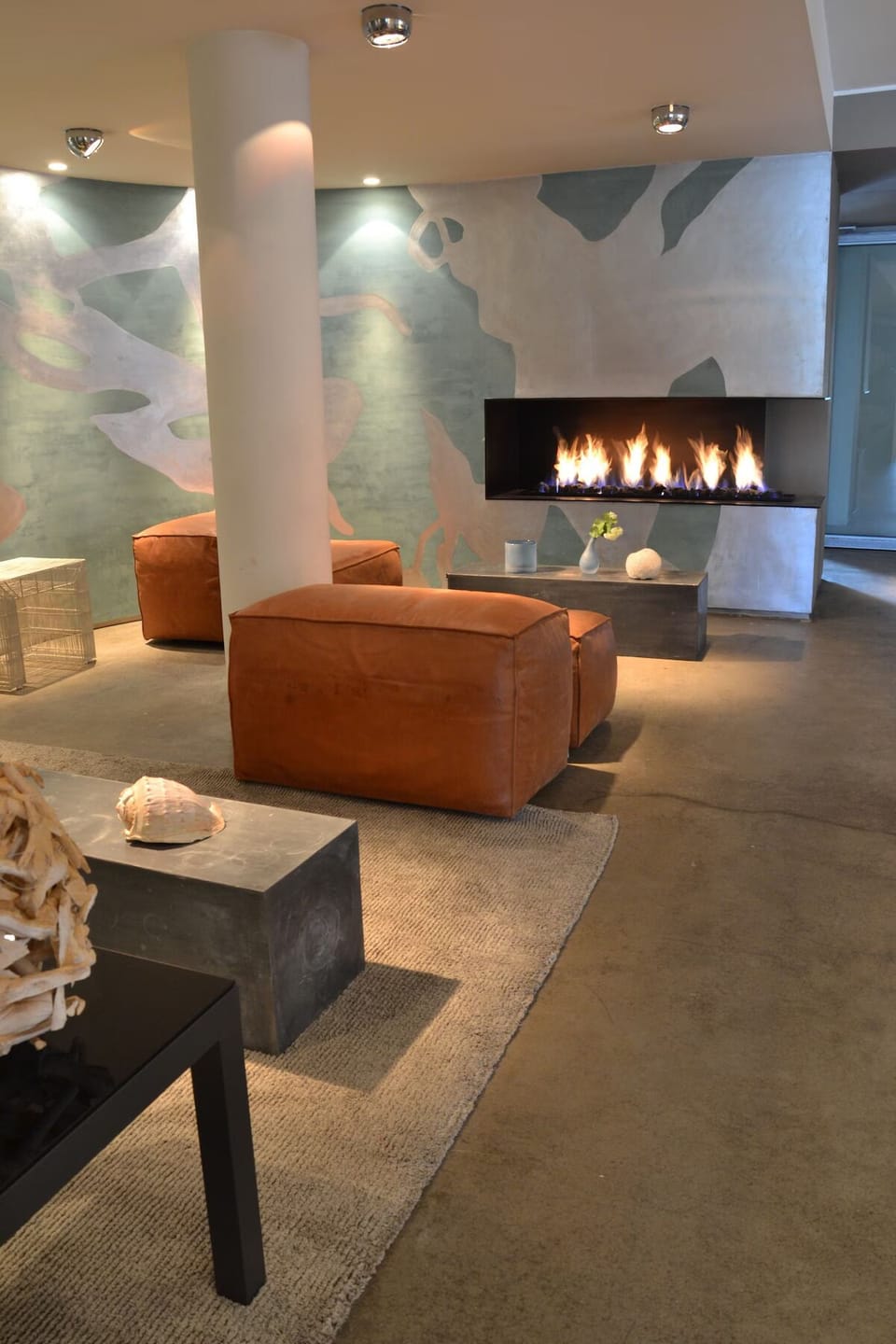 Unwind by the glowing fireplace in a stylish lounge.