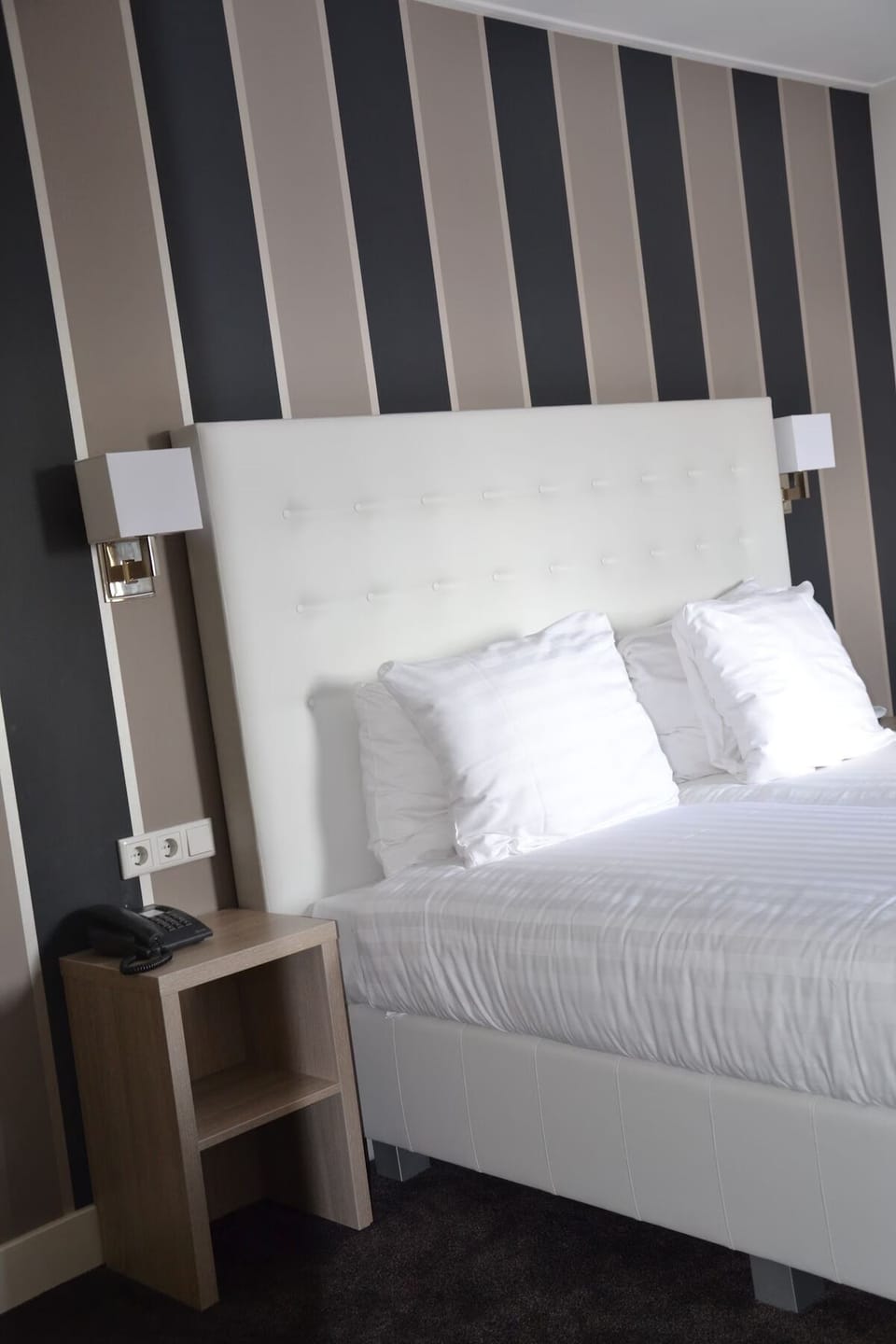 Sink into a plush headboard under warm bedside lighting.