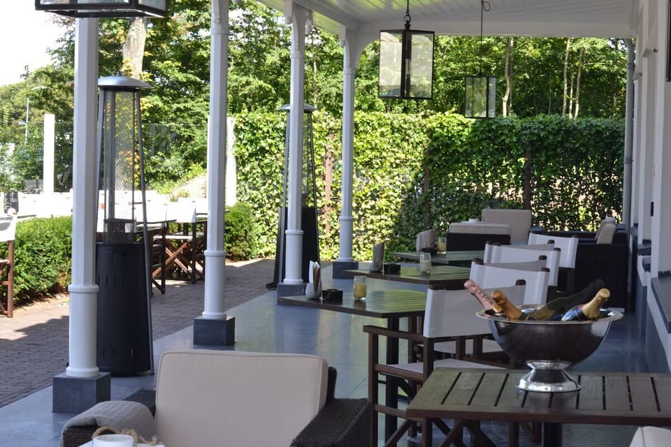 Sip and lounge under the covered veranda, shaded and serene.