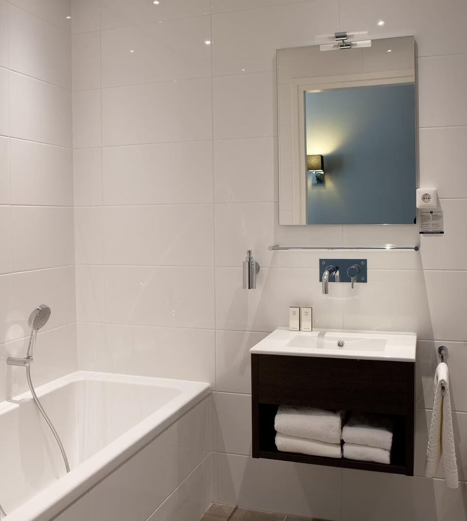 Freshen up with a sleek vanity and neatly stocked towels.