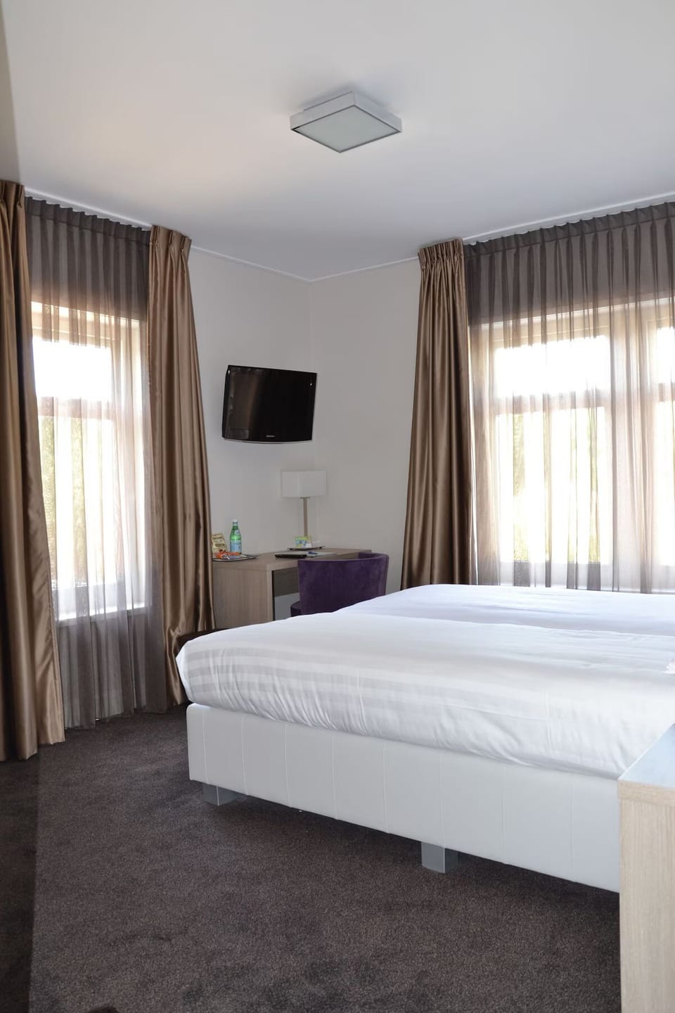 Wake up to soft daylight filtering through floor-to-ceiling curtains.