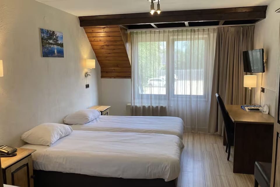 Stretch out in airy twin beds beside a bright window.