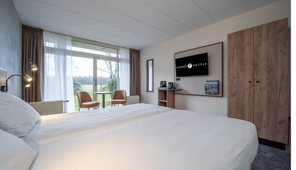 Stretch out with a big TV and peaceful window outlook.