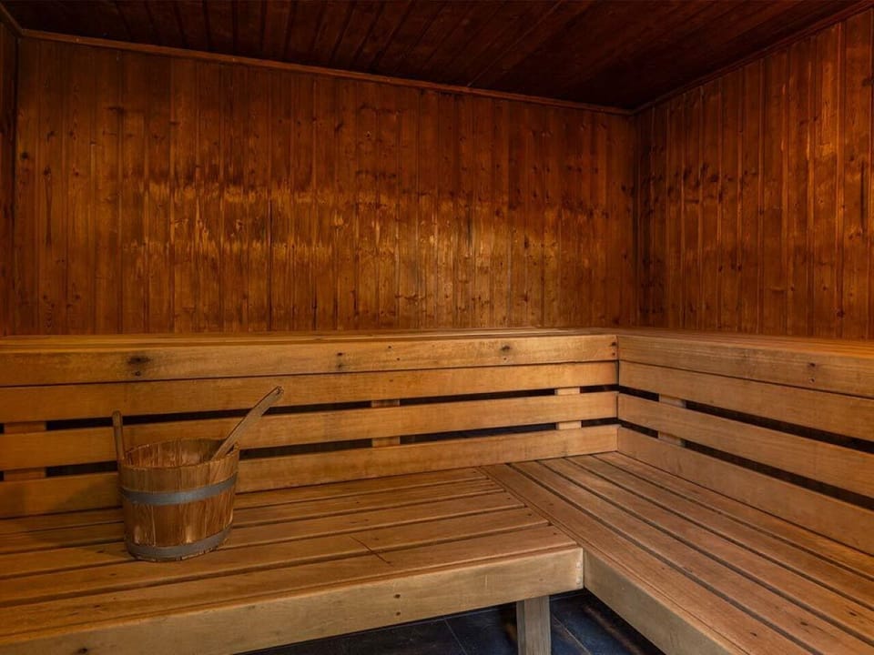 Recharge in the warm wooden sauna after a long day.