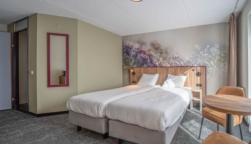 Settle in with roomy twin beds and a cozy table.