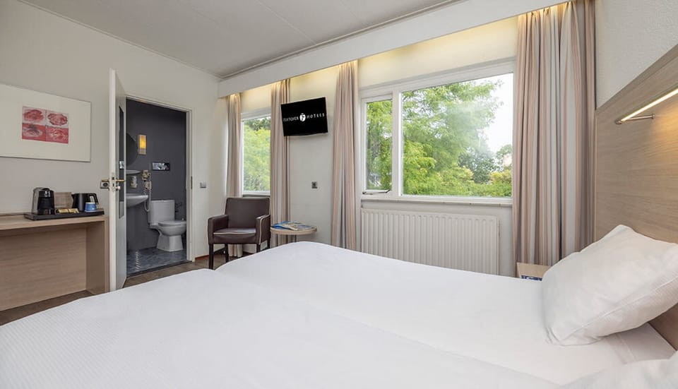 Unwind in crisp linens with calming views outside.
