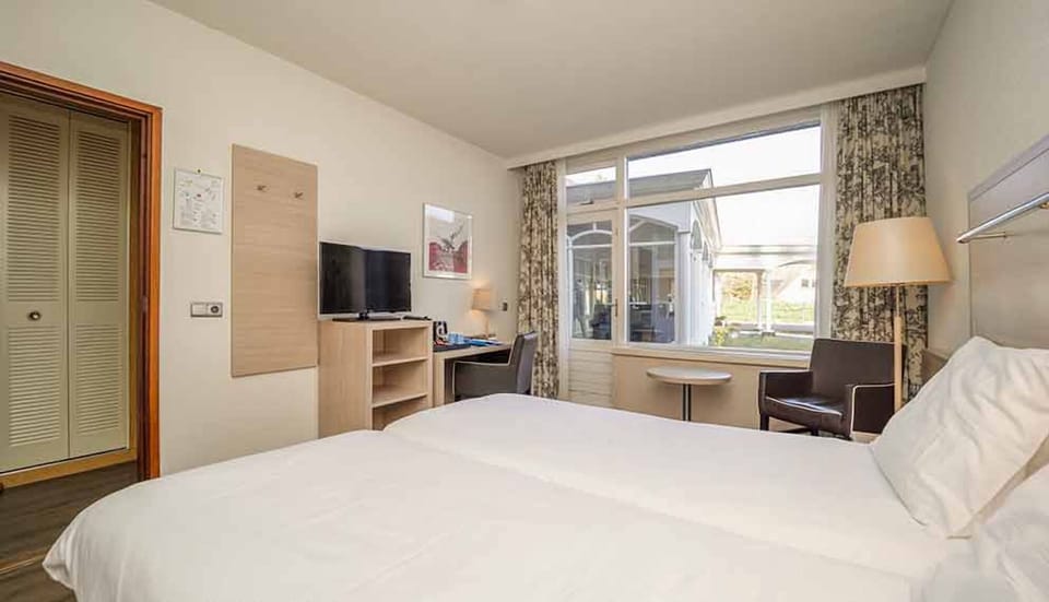 Recharge in a spacious room with lounge seating and daylight.