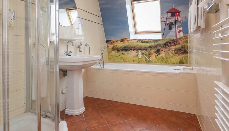 Refresh easily with bright vanity, shower, and deep soaking tub.