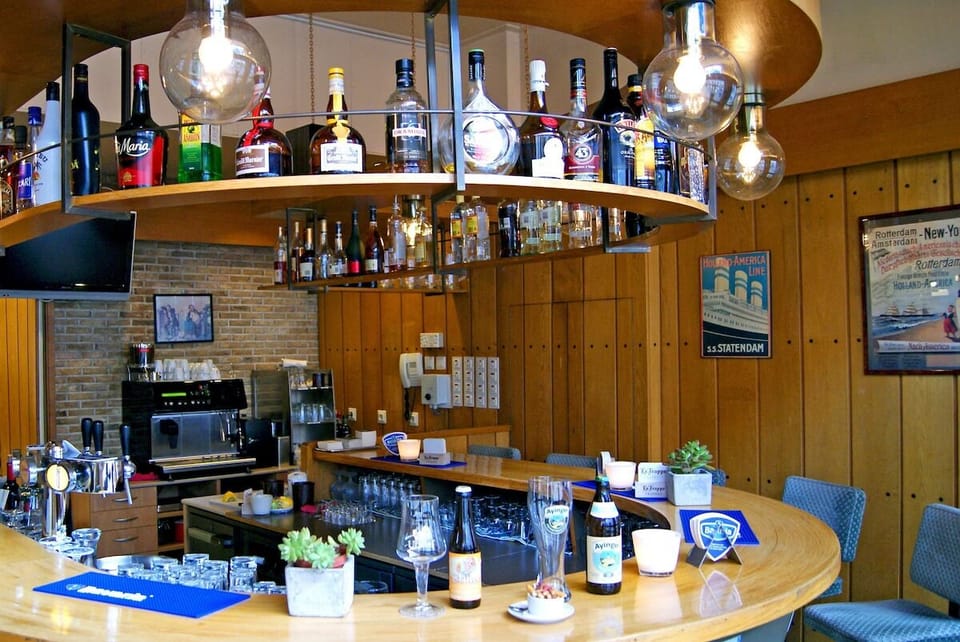 Sip cocktails at the lively bar under vintage bulbs.