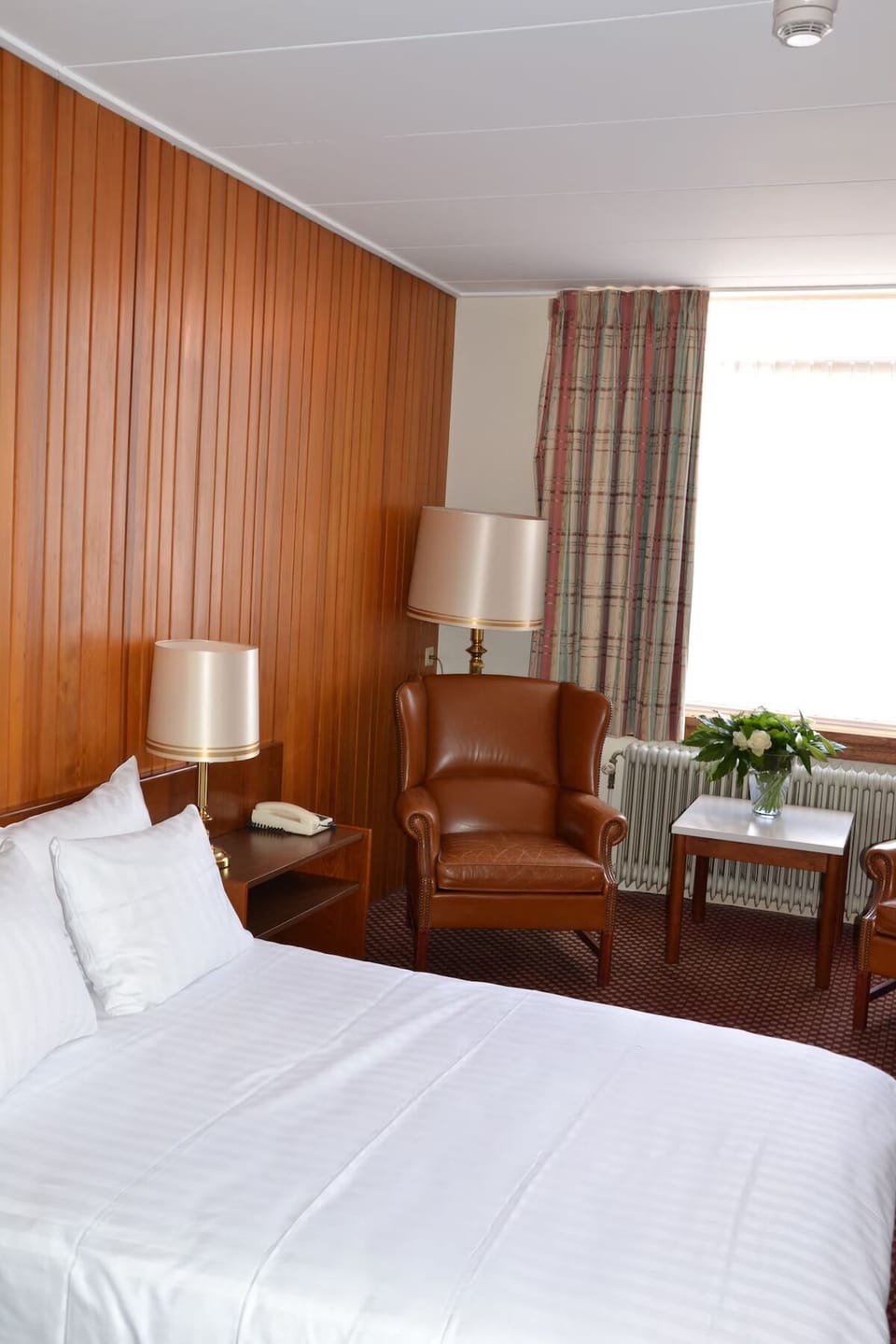 Settle into a warm room with armchair and soft light.