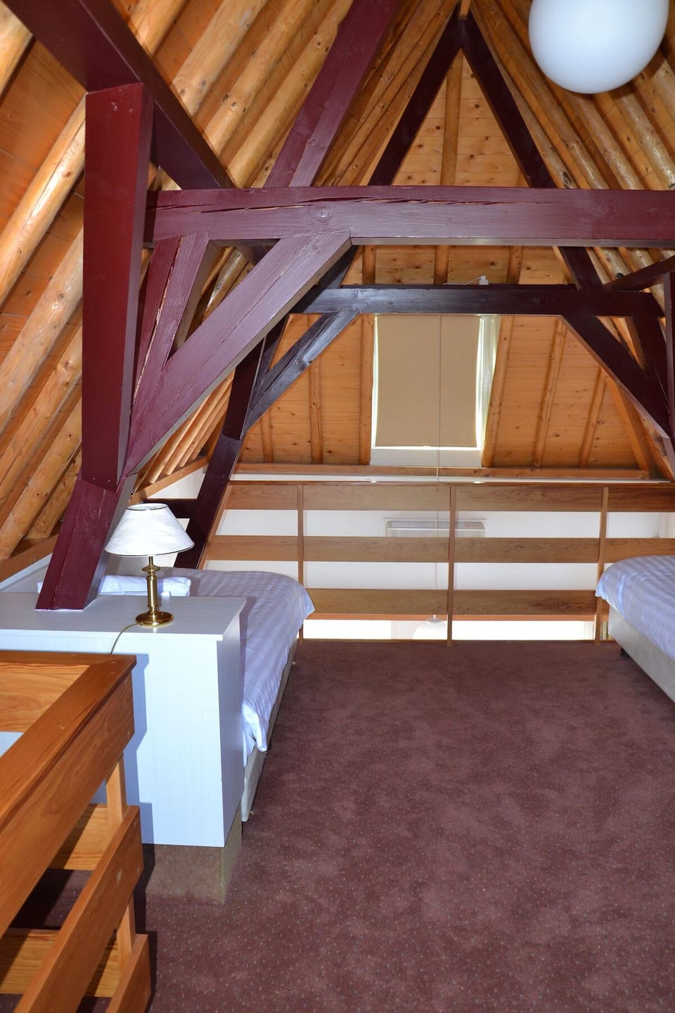 Escape upstairs to a charming loft bedroom under rafters.