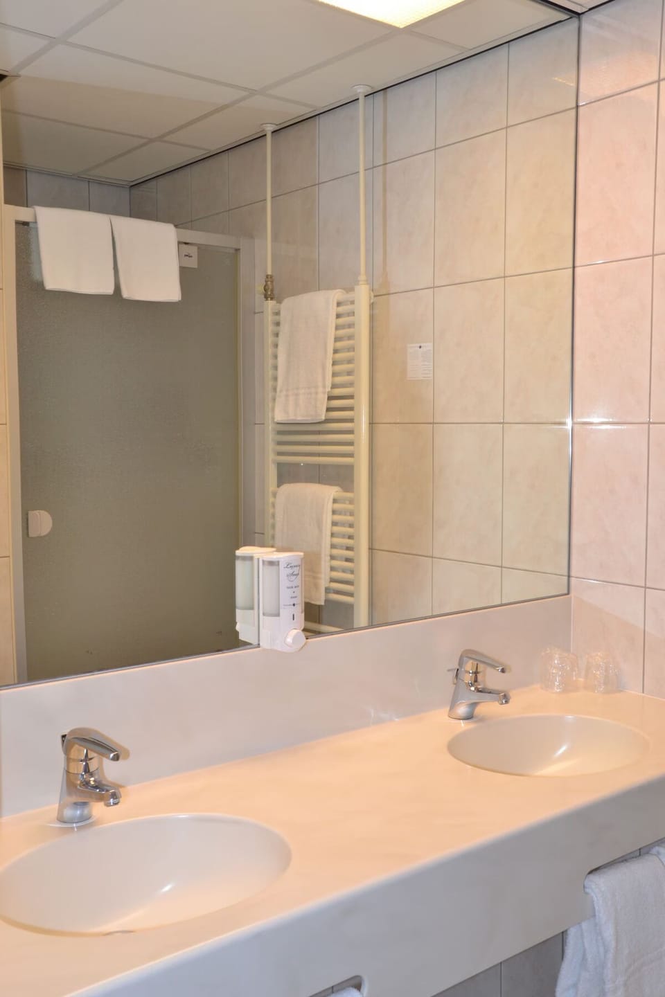 Freshen up with a spacious double vanity and bright mirror.