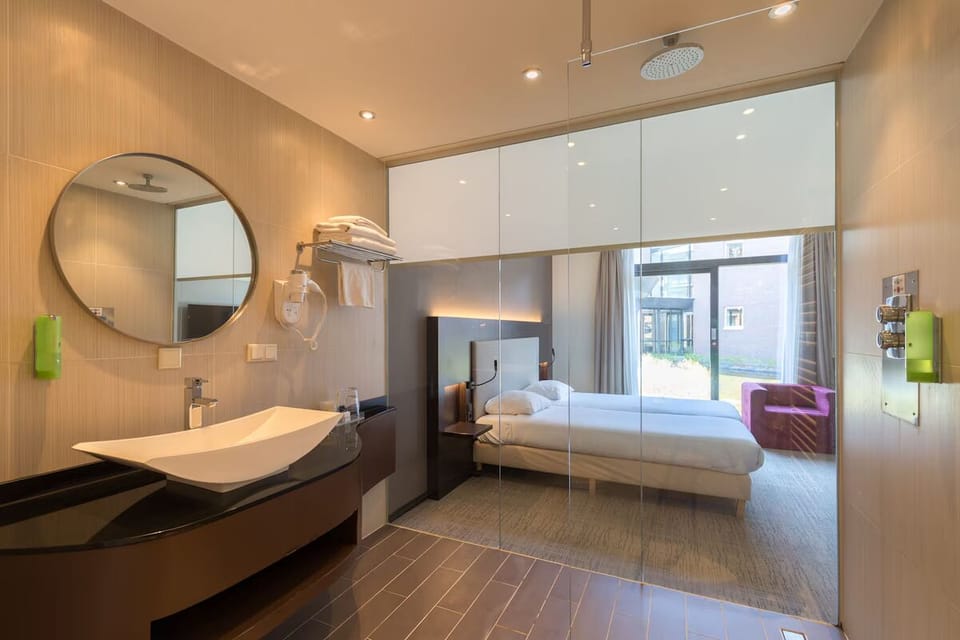 Refresh under a rainfall shower in a sleek, bright bath.