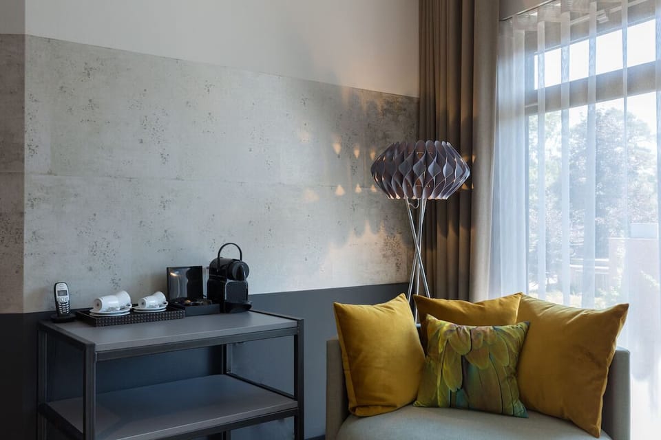 Settle in with coffee beside cozy seating and soft light.