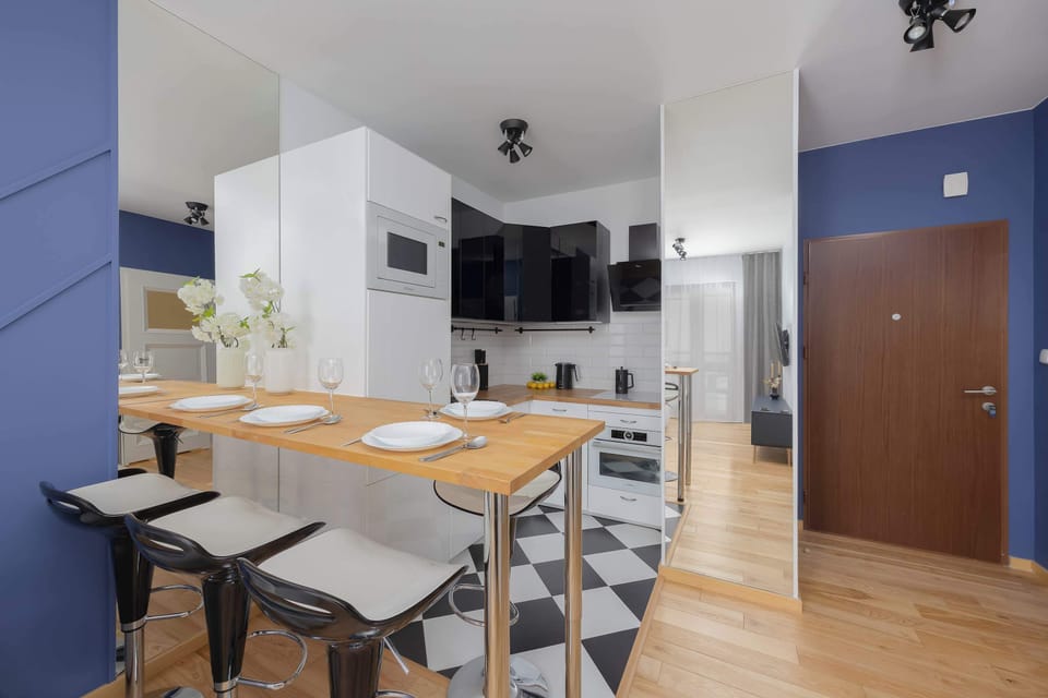 Dining table and a kitchenette in the background.