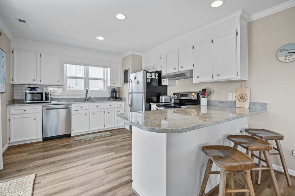 Your spacious kitchen features granite countertops, modern appliances, and a breakfast bar where you'll love sipping morning coffee.