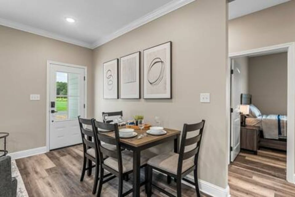 Gather for meals in this inviting dining area, bathed in natural light. Perfect for family dinners or romantic evenings. Book your stay at 119 Baywood for a memorable getaway!