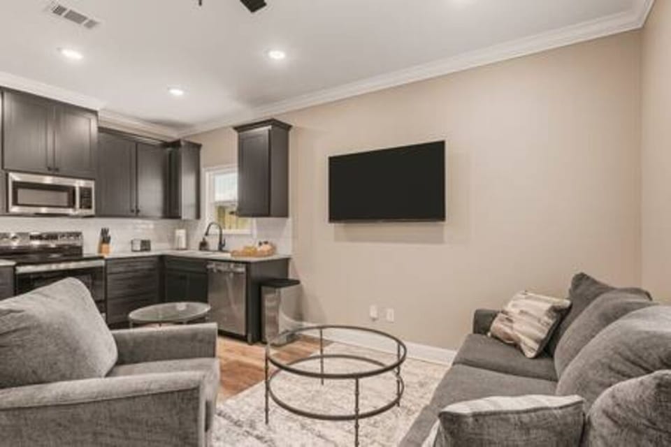 Relax in this spacious living area with a modern, fully-equipped kitchen. Perfect for families and couples to unwind after a day of exploring. Enjoy movie nights on the large TV!