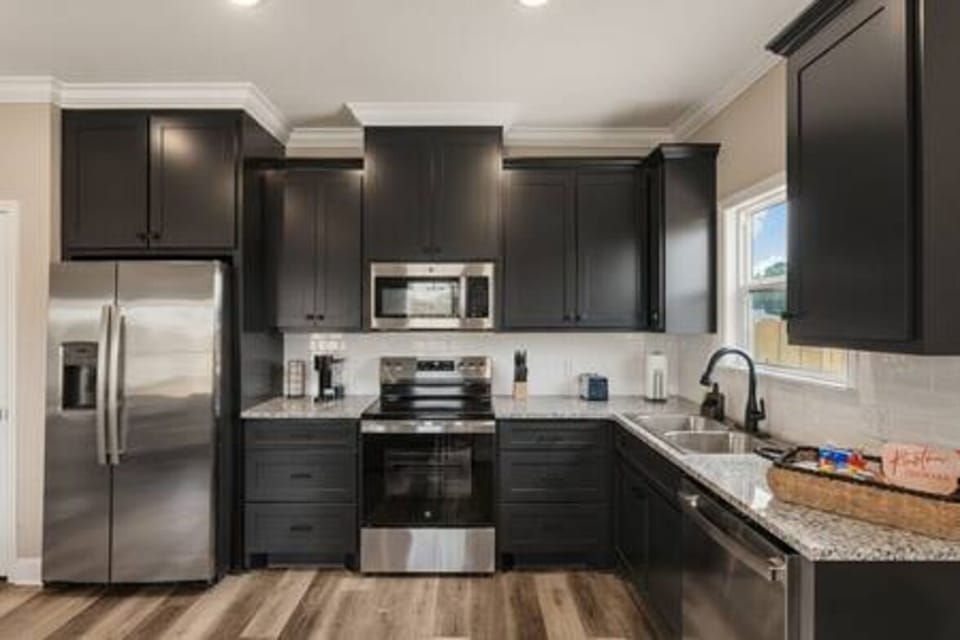 Whip up delicious meals in this spacious, modern kitchen. Fully equipped with stainless steel appliances and ample counter space, it's perfect for creating lasting family memories. 