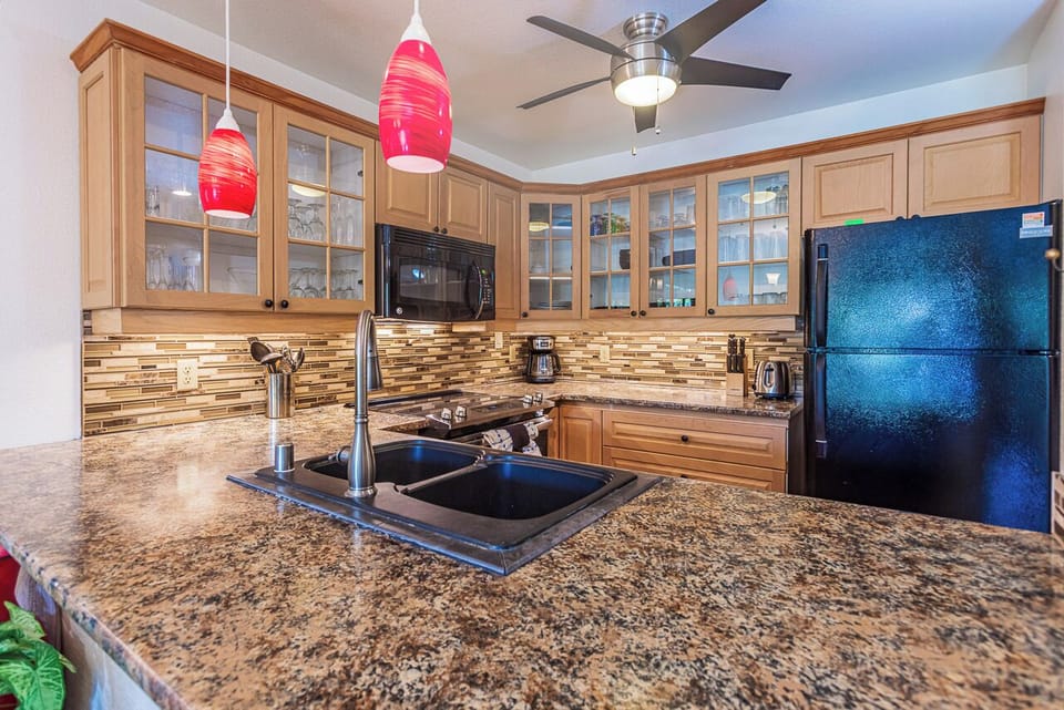 Cook with ease in your fully equipped kitchen featuring modern appliances, and stylish pendant lighting.