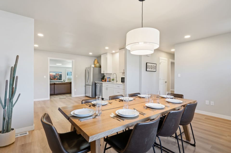 Gather around this beautifully set dining table where your group can enjoy meals together in the bright, open-concept space.