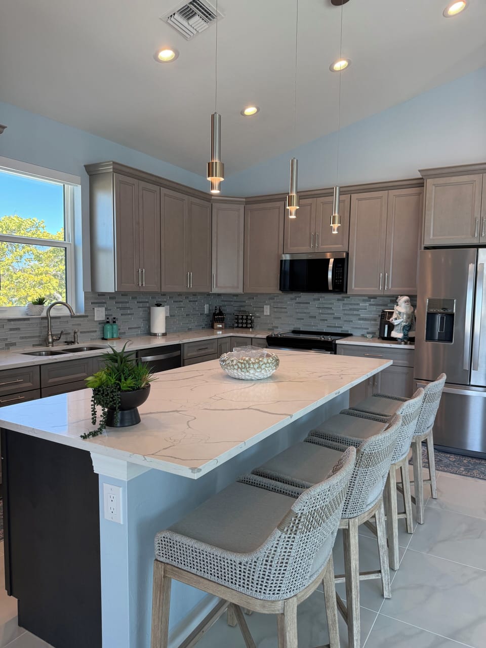 Your modern kitchen features sleek appliances, marble counters, and stylish seating where you'll enjoy cooking and casual meals together.