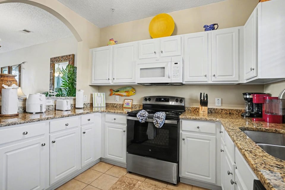 `The modern kitchen features all-new appliances, including a large refrigerator and plenty of cabinet space for your favorite snacks.`