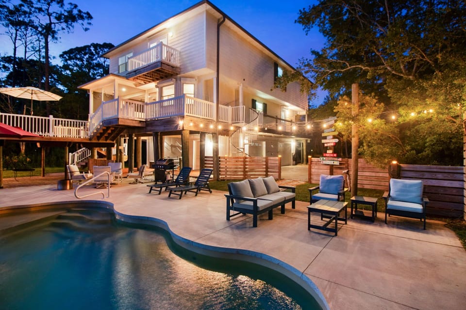 Pool area with outdoor TV and plenty of comfortable seating for relaxing and entertaining.
