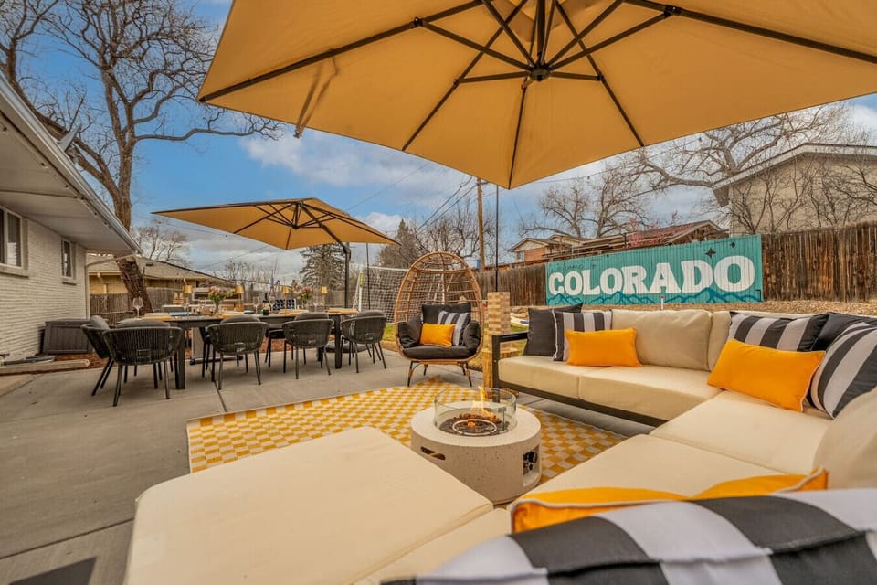 Fully fenced yard with outdoor dining, lounge seating, two fire pits, ping pong, hot tub, and more!
