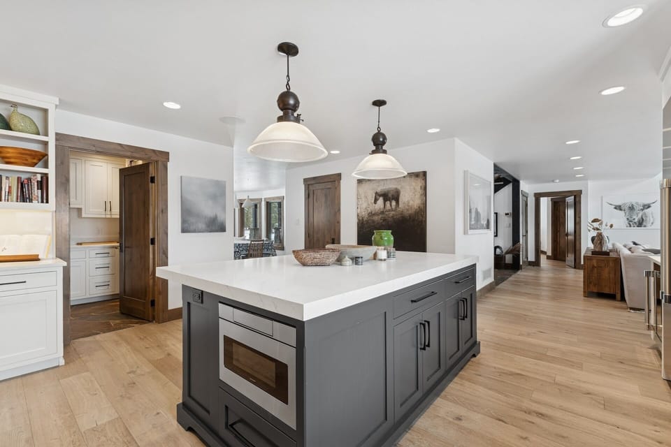 Your spacious gourmet kitchen awaits with gleaming quartz countertops, professional appliances, and elegant pendant lighting for memorable meal preparation.