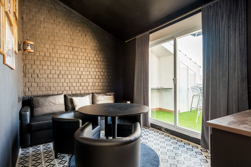 Our upper-floor lounge serves as a versatile space for working or intimate evening drinks, featuring direct access to the Skybar terrace. The dedicated bar area is perfect for preparing refreshments without having to head back down to the main kitchen.