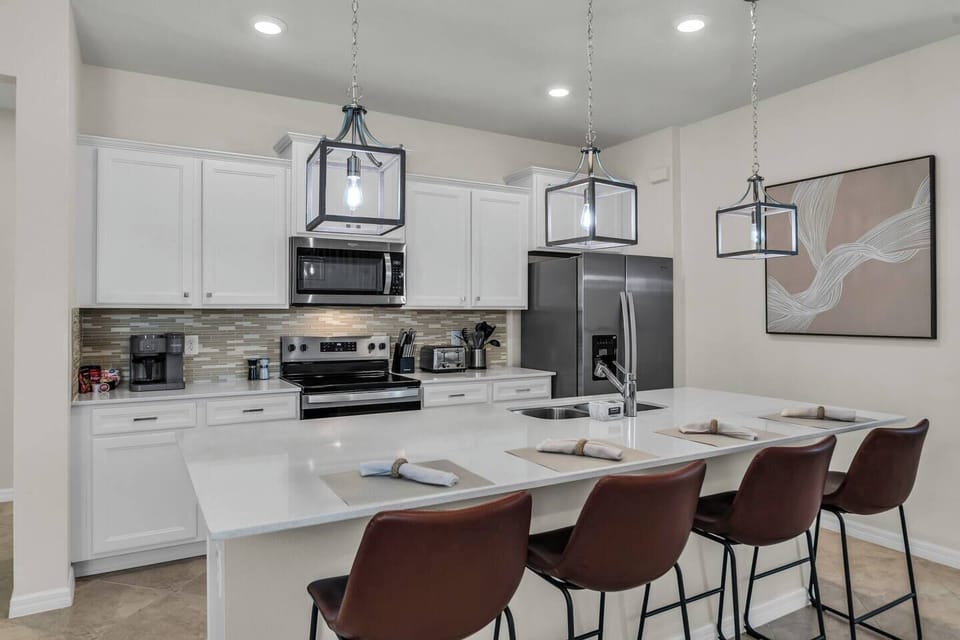 Open-concept kitchen & dining space w/ pendant lighting & plenty of seating.