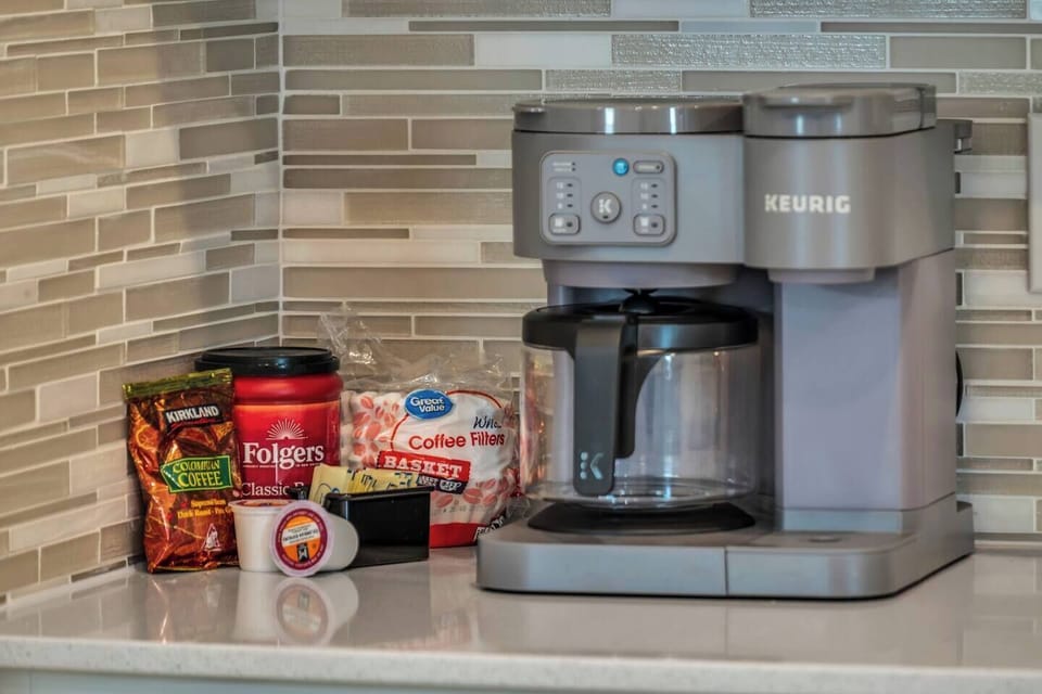Handy coffee station w/ Keurig & assorted snacks to fuel your mornings.