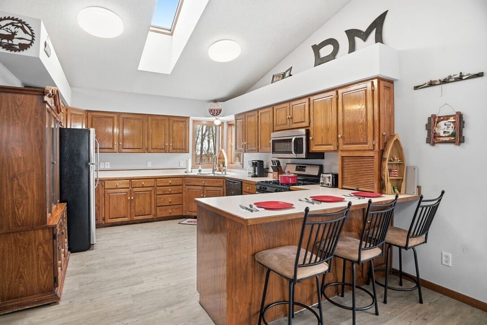 Kitchen | Breakfast Bar Seating & Stainless Steel Appliances | Open Layout with Skylights