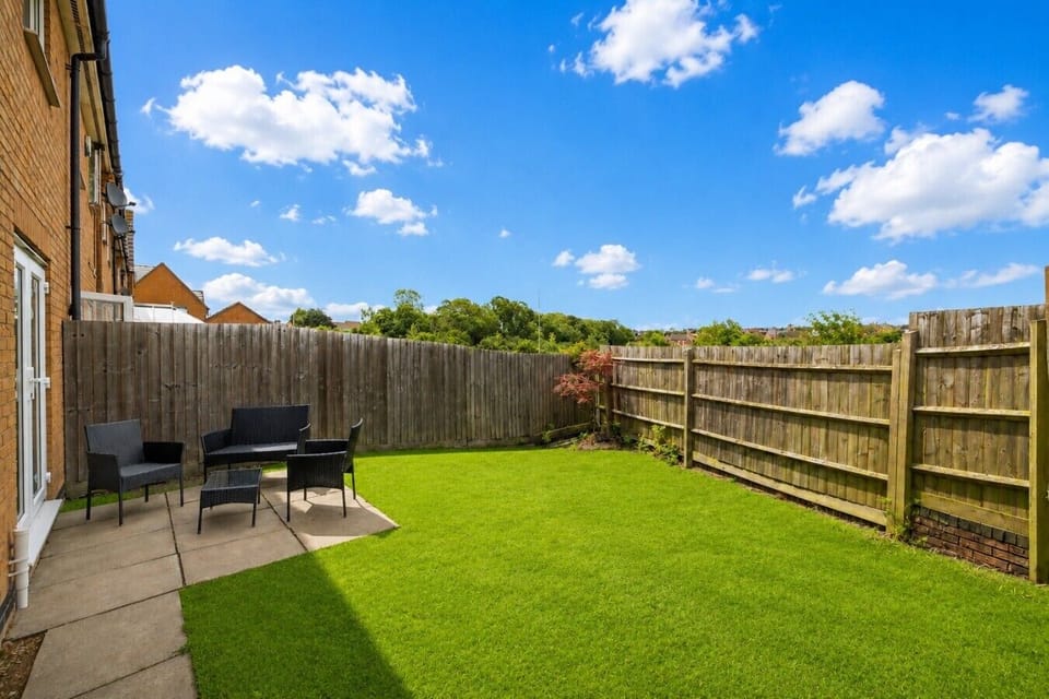 Fully fenced private garden with outdoor seating.
