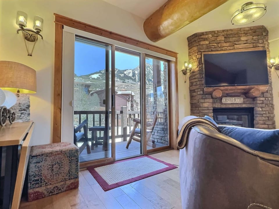 【Living Room】Stone gas fireplace and a slider straight to the view