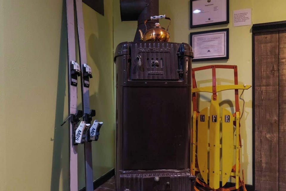 Ski gear and a vintage stove create a fun, rustic mountain vibe!