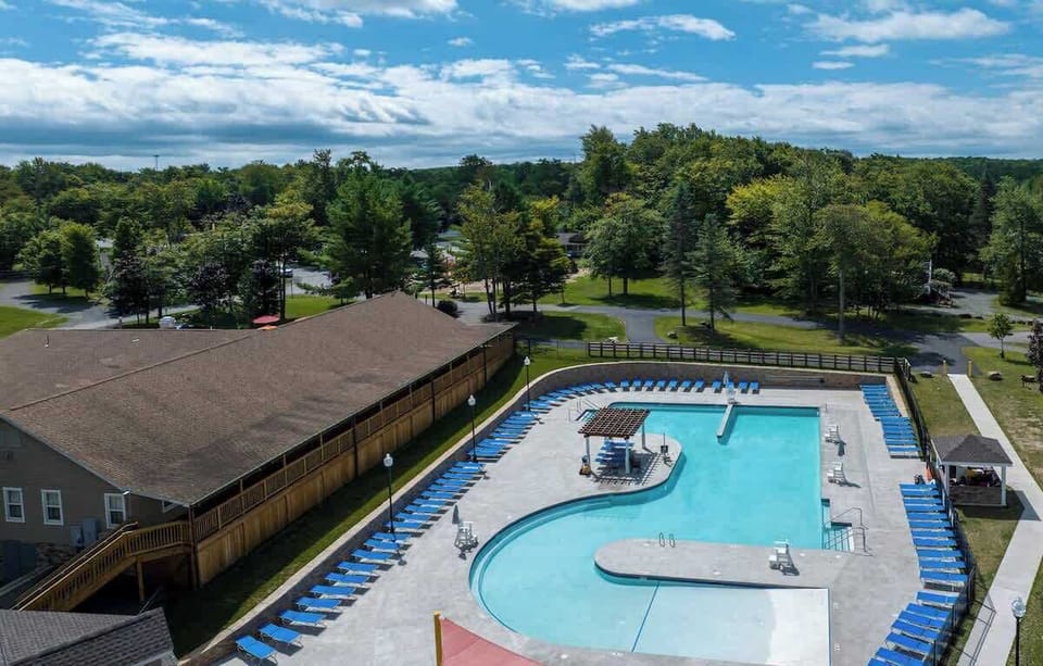 Dive into fun at the community expansive pool surrounded by lush greenery and lounge chairs!