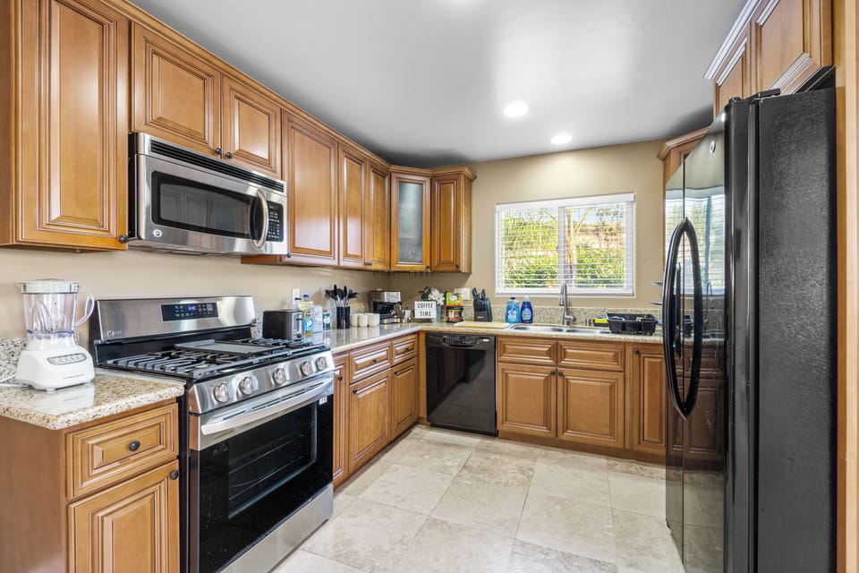 Essentials covered: stove, coffee maker, microwave, fridge, and dishwasher.