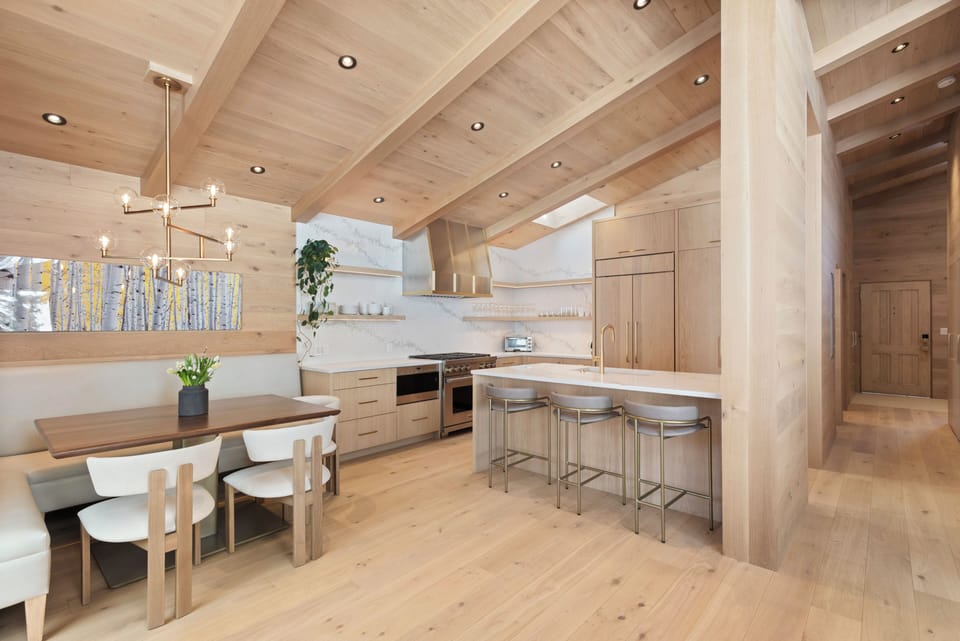 Fully equipped kitchen with natural stone countertops, custom cabinetry, and high-end appliances including a Wolf Range.