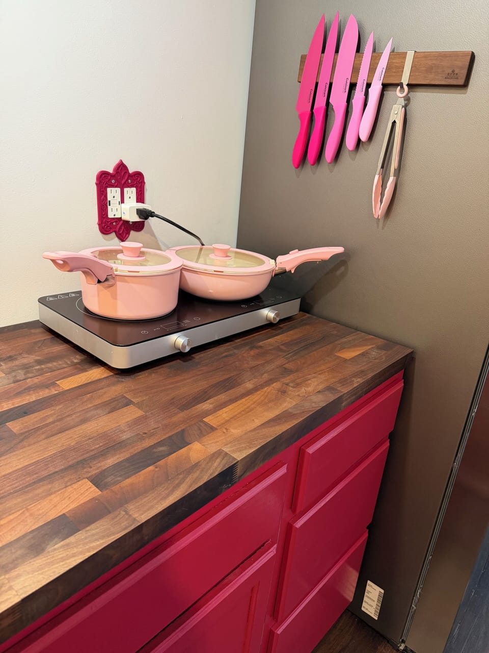 Induction stovetop with vibrant pans that you couldn’t lose in a snowstorm.