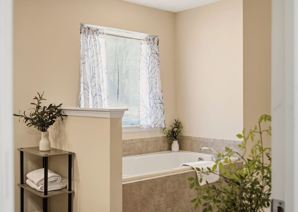 The primary bedroom's ensuite features a shower and a soaking tub.