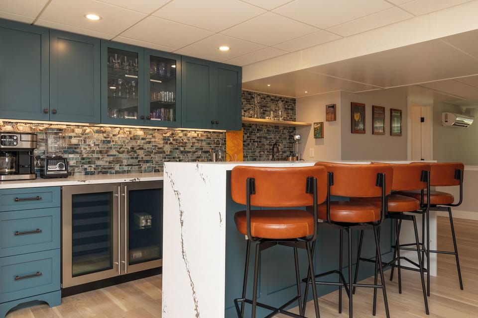 The spacious basement / game room with a bar, 120" projector screen and games