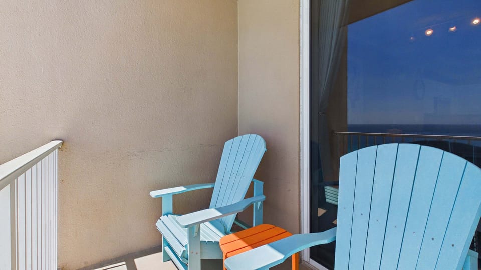 Spacious balcony with Adirondack seating for perfect viewing of the gulf