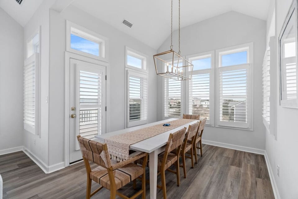 Sun-filled dining space surrounded by windows—perfect for meals, games, and gathering with your group.
